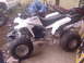 1994 Ford Bronco - A white ATV with 'YF200' visible is parked in a cluttered area with other vehicles.